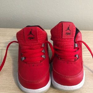 Red and gray child’s size 6 Nike shoe.